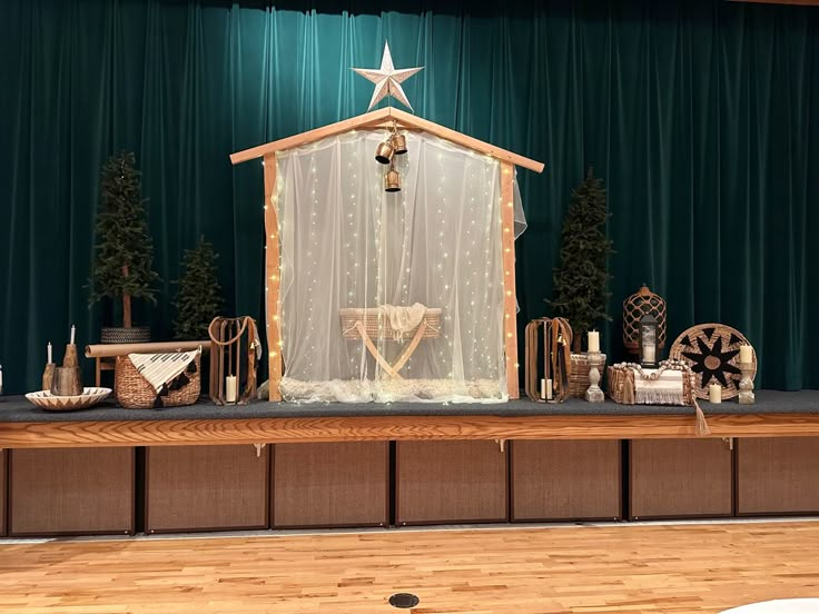 a stage set up for a christmas show with lights and decorations on the sidelines