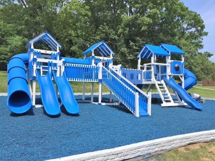 a blue and white playground set with slides