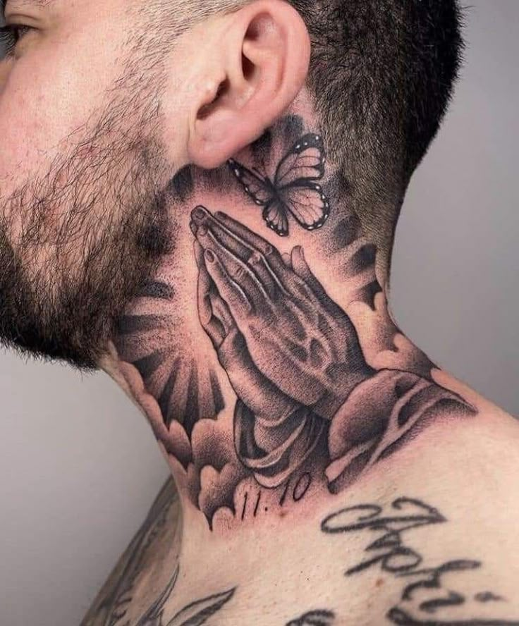 a man with a tattoo on his neck has a praying hand and a butterfly above it