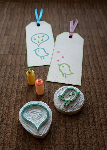 some crafting supplies are laid out on a table with tags and thread spools