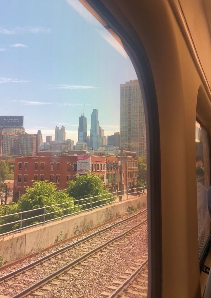 the view from inside a train looking out at a city