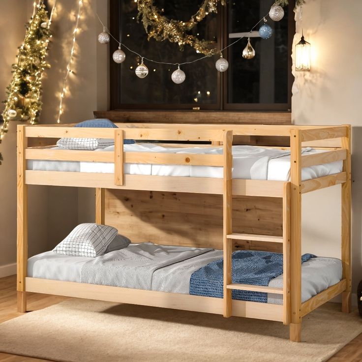 a wooden bunk bed sitting on top of a hard wood floor next to a christmas tree