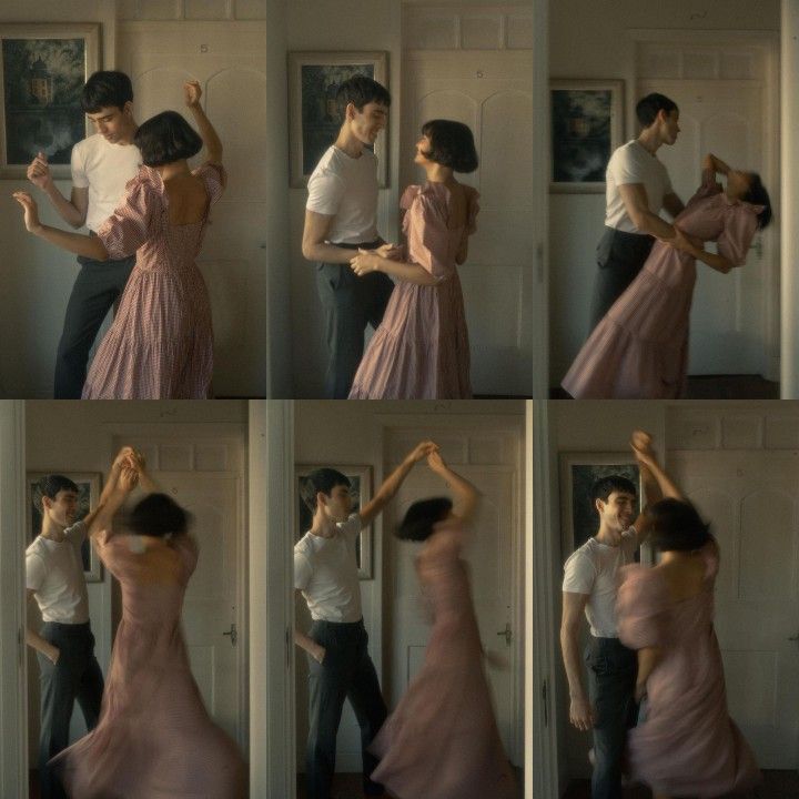 a man and woman dancing together in front of a door with their arms around each other