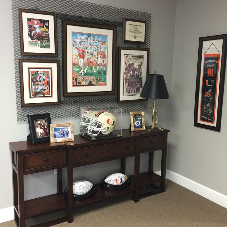 there is a football themed room with pictures on the wall and other sports related items