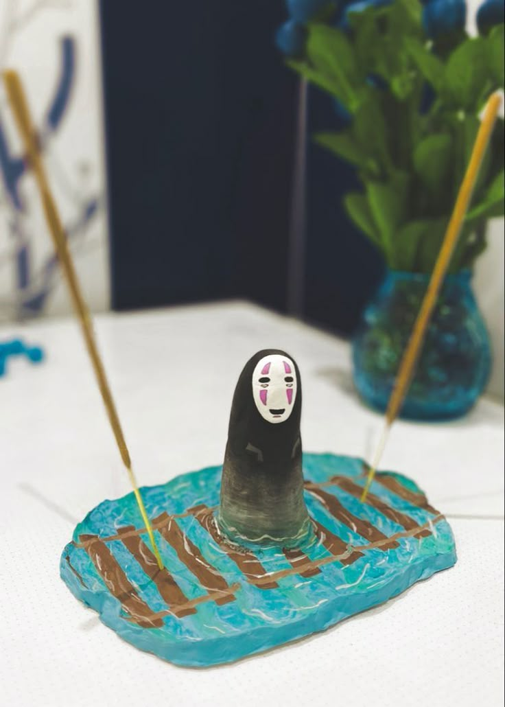 a table topped with blue vases filled with water and chocolate covered donuts on top of it