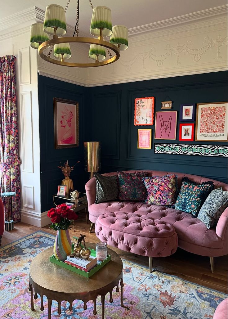 a living room filled with lots of furniture and paintings on the wall next to a coffee table