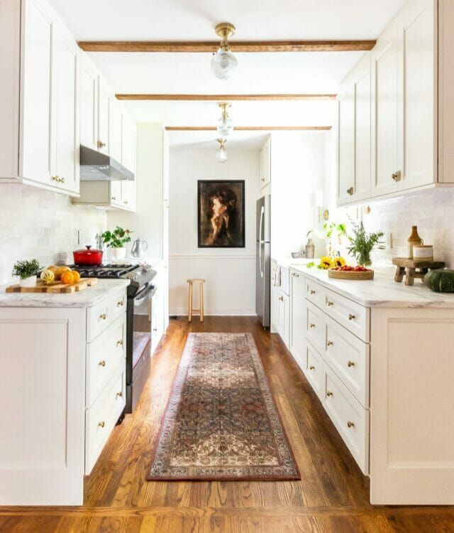 the kitchen is clean and ready for us to use it's white cabinetry