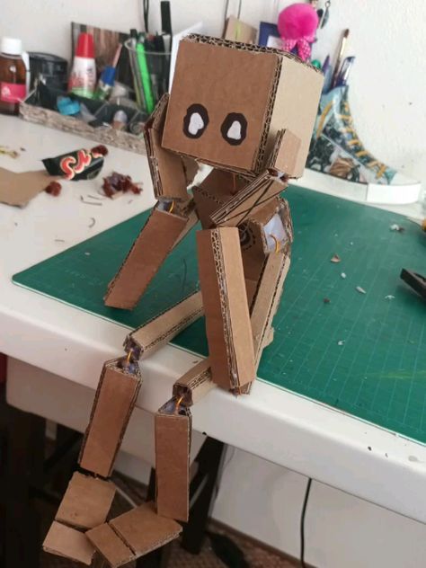 a cardboard robot sitting on top of a table