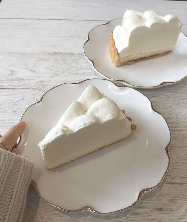 two plates with slices of pie on them, one being held by a woman's hand