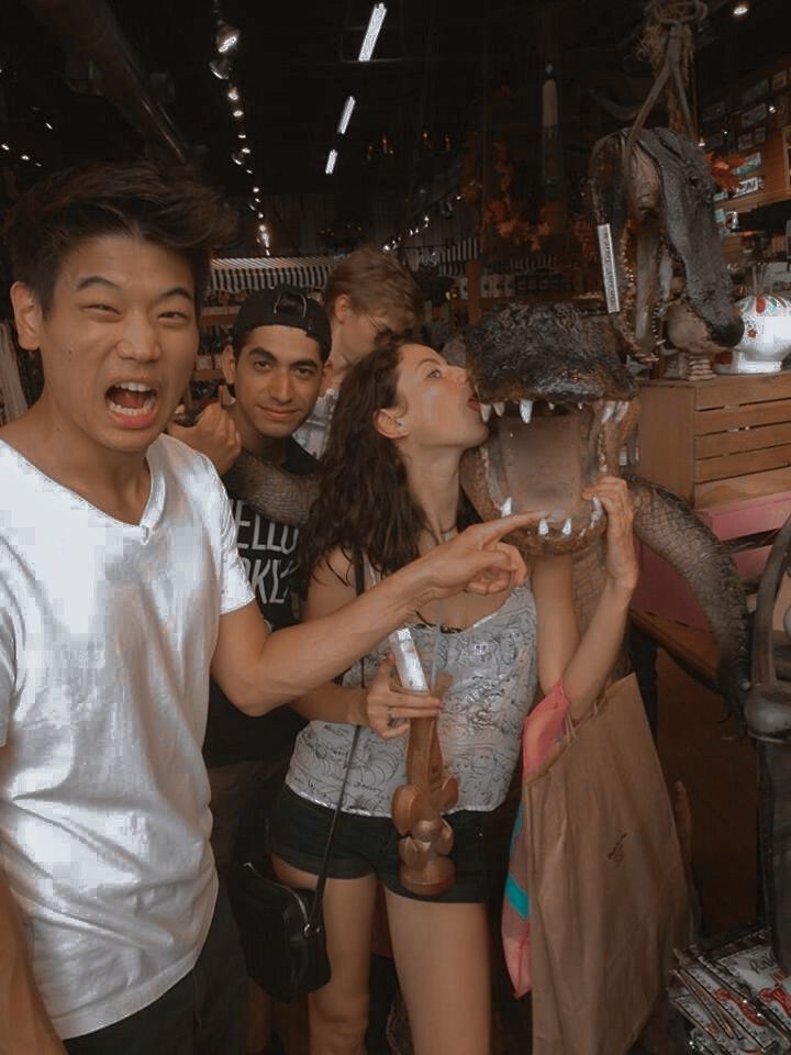 a group of young people standing next to each other in front of a store display