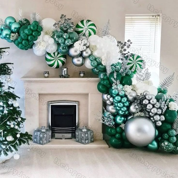 a fireplace decorated for christmas with green and silver decorations