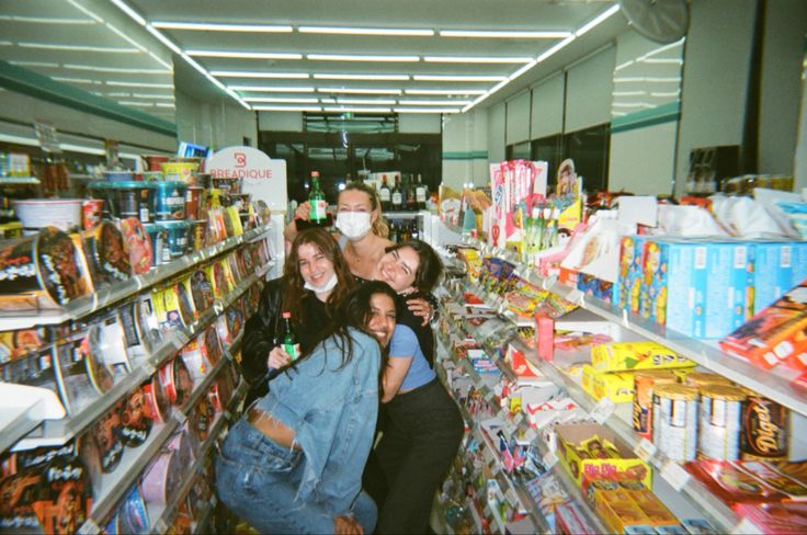 four people in a grocery store with masks on