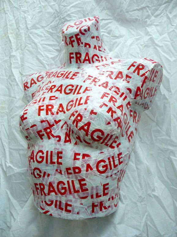 a fire hydrant covered in plastic wrap on top of a white sheeted paper