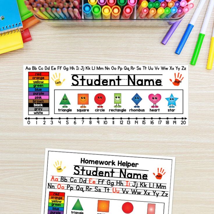 two student name cards with crayons and pencils