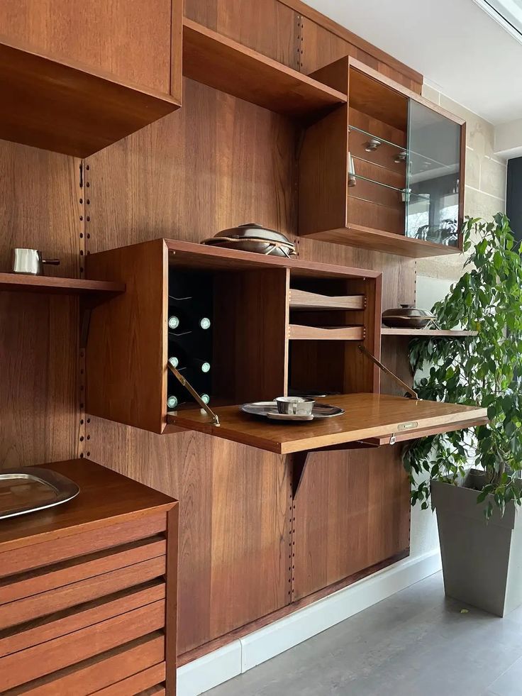 a room with wooden shelves and plants in it