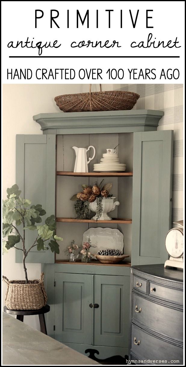 an antique corner cabinet is painted in blue and green with the words primitive antiques written above it