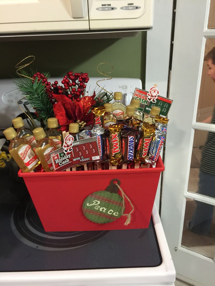 a red container filled with lots of liquor sitting on top of a stove