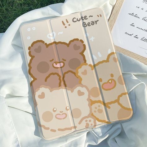 an ipad case with a teddy bear design on the front and back cover is laying on some grass