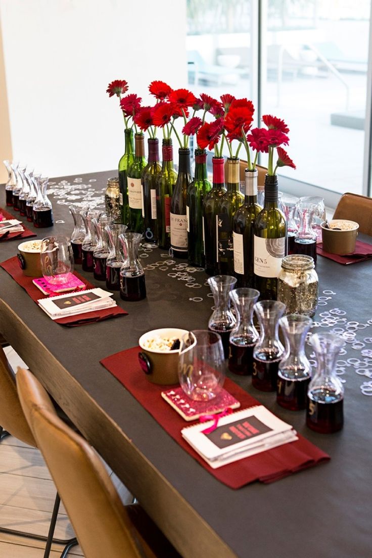 the table is set with wine bottles, glasses and other items for dinner or an event