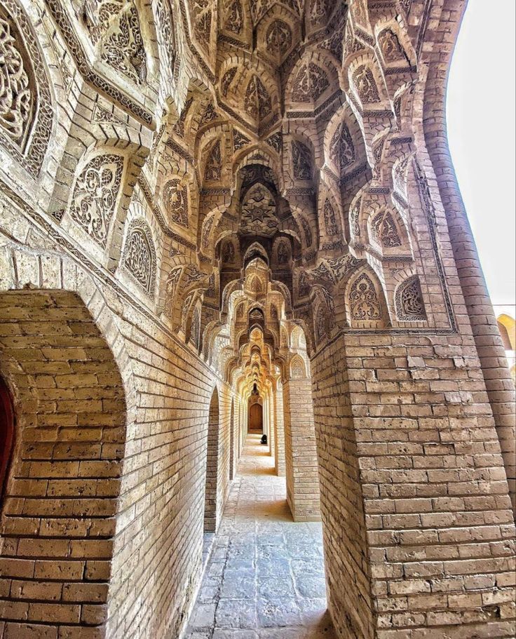 an archway in the middle of a building with brick walls and arches on both sides