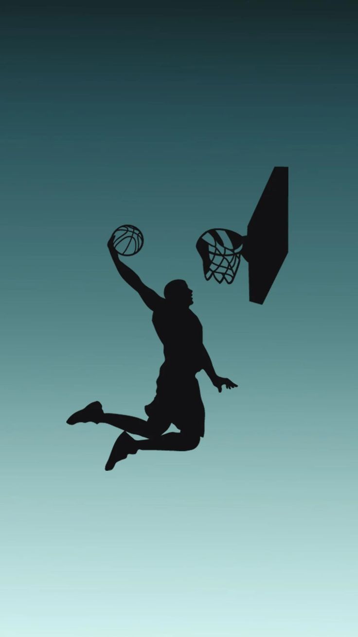 the silhouette of a basketball player is jumping up into the air to dunk the ball