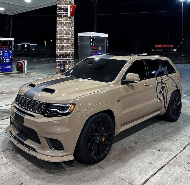 a beige jeep parked in front of a gas station