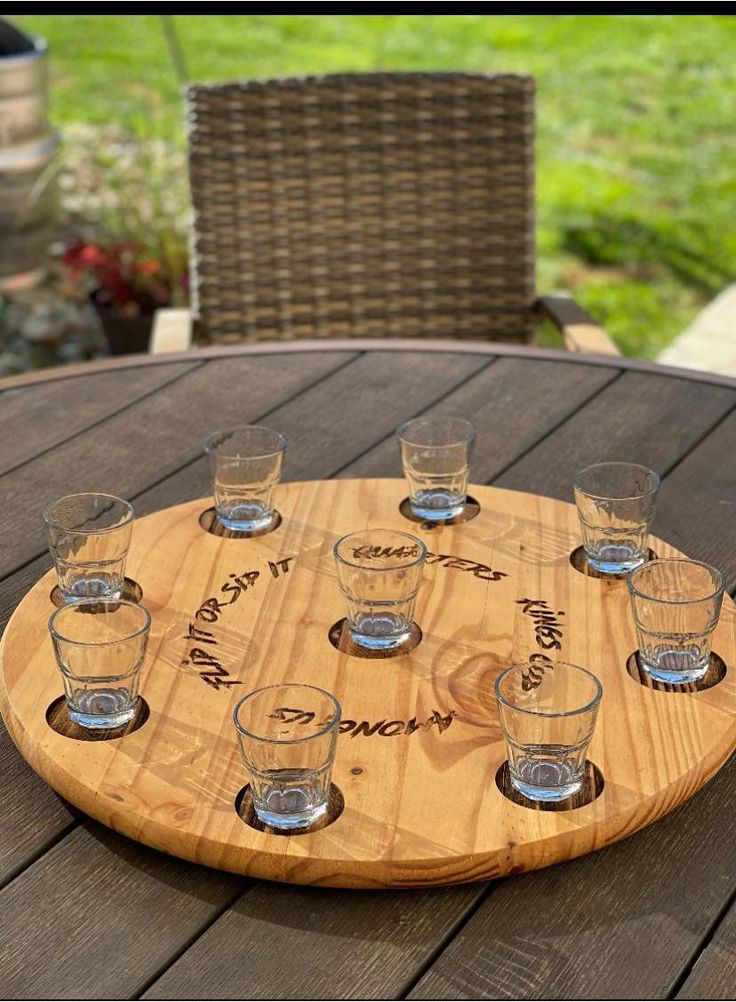 a wooden tray that has glasses on it