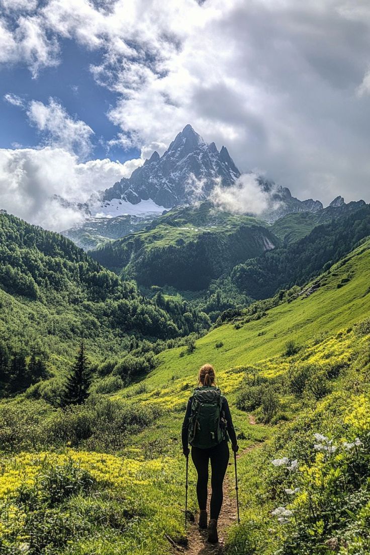 a person hiking up a trail in the mountains