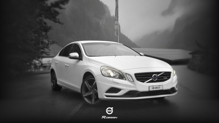 a white car parked in front of a mountain