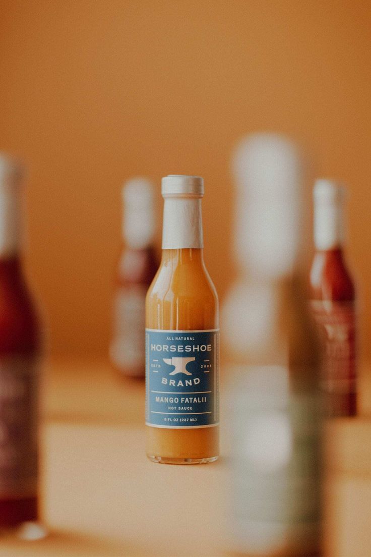 several bottles of sauce sitting on top of a table