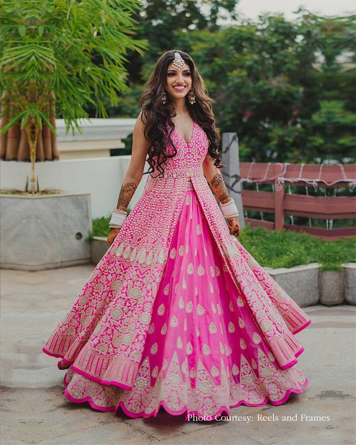 a woman in a pink and gold dress