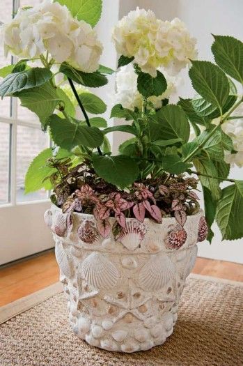 a white flower pot sitting on top of a rug next to a window sill