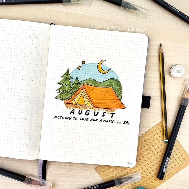 an open notebook with the words august written on it next to pencils and markers