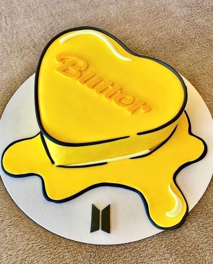 a yellow hat with the word bump on it is sitting on top of a white plate