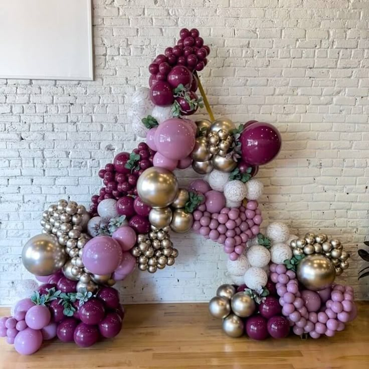 the letter k made out of balloons and grapes