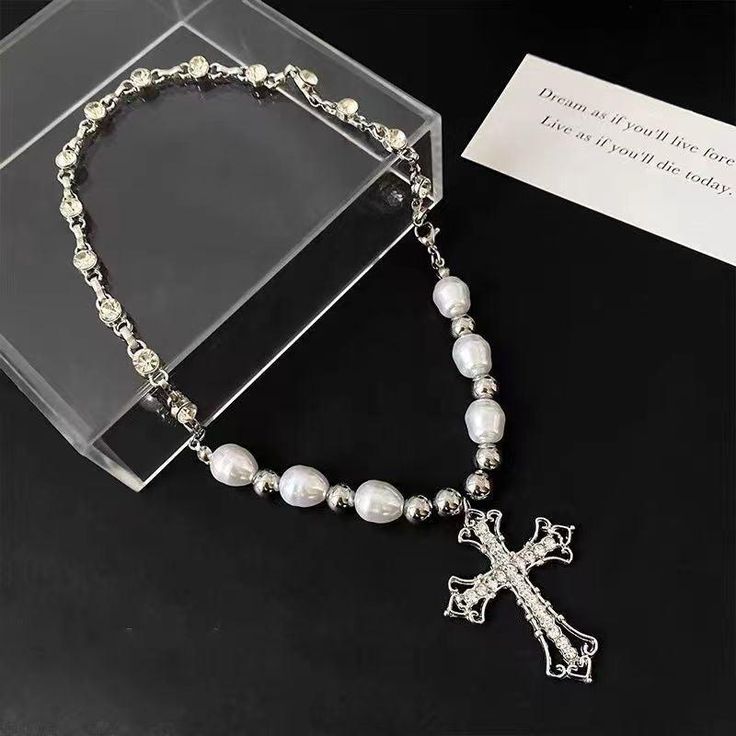 Our cross pearl necklace, suspended from a 39cm chain, exudes an air of elegance. Its refined design makes it an ideal gift for special occasions, delivered right to your doorstep in an exquisite gift box. Chain length 39cm (15inch) Elegant design Shipped with gift box Y2k Black Aesthetic, Y2k Blue Aesthetic, Y2k Pink Aesthetic, Fashion Forward Outfits, Aesthetic Clothing Stores, Retro Men, Y2k Outfits, Cross Jewelry, Dress For Short Women