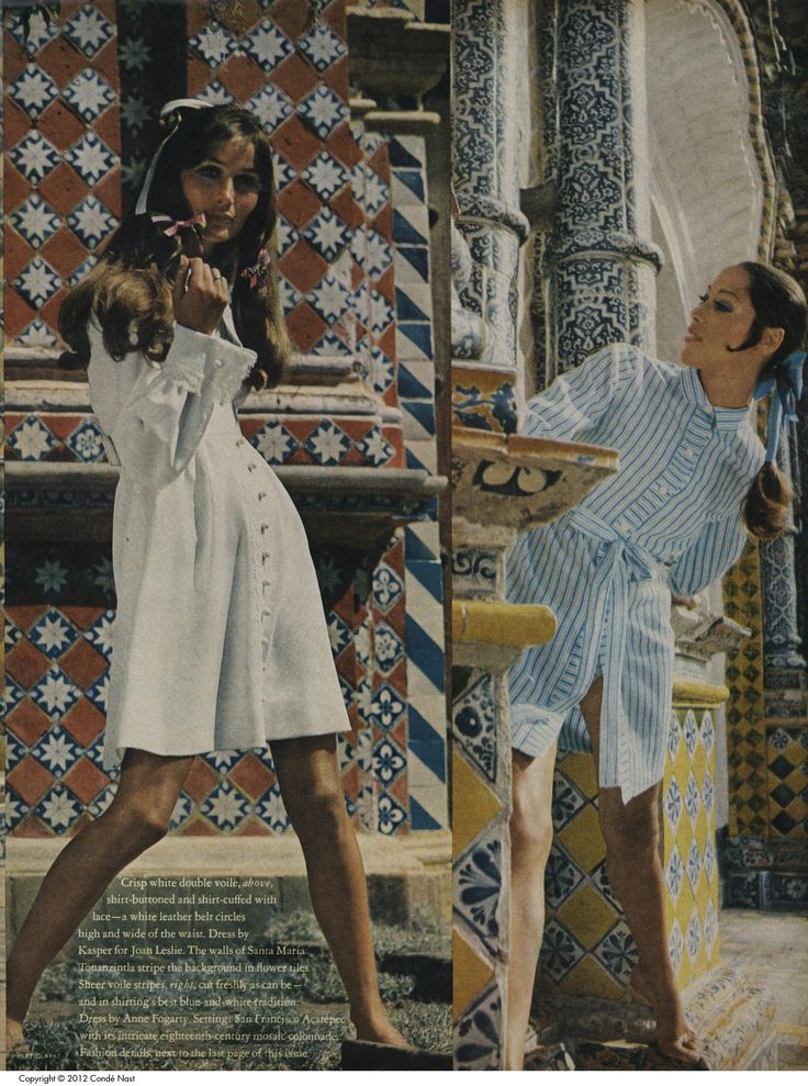 two women in white dresses and one is holding a tennis racquet