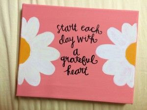 a pink sign with daisies on it that says, start each day with a grateful heart