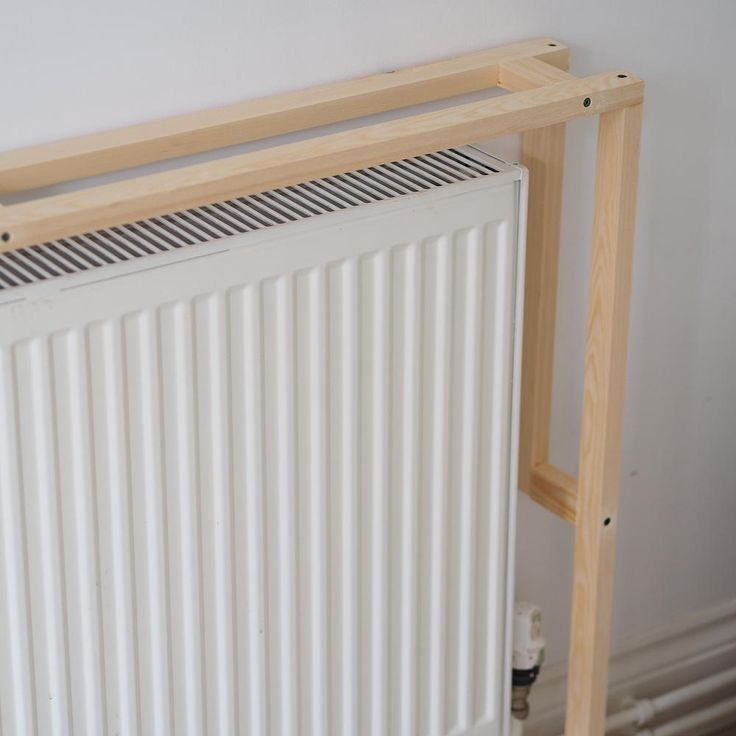 a white radiator sitting next to a wall