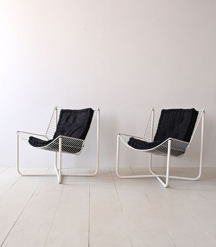 two chairs sitting next to each other on top of a hard wood floored floor