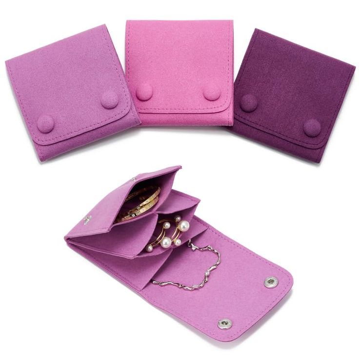 three wallets with pearls on them sitting next to each other in purple and pink colors