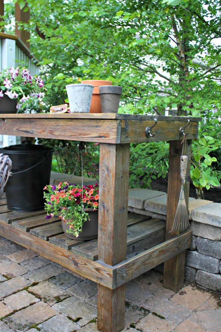 an outdoor potting bench with flowers on it