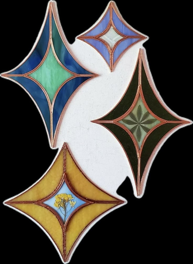 three different colored stained glass designs on a white background