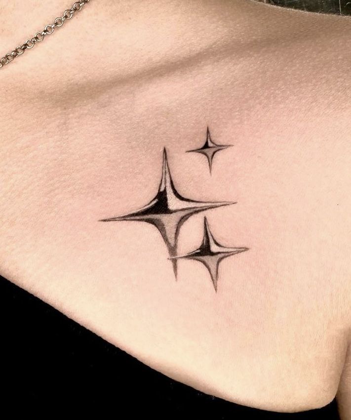 a woman's chest with three small stars on the top and bottom part of her stomach