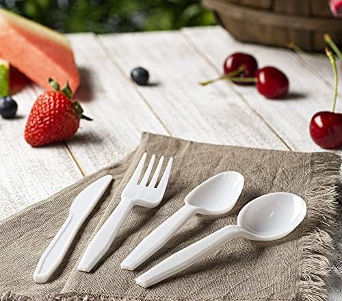 four forks, two spoons and one knife on a napkin with fruit in the background