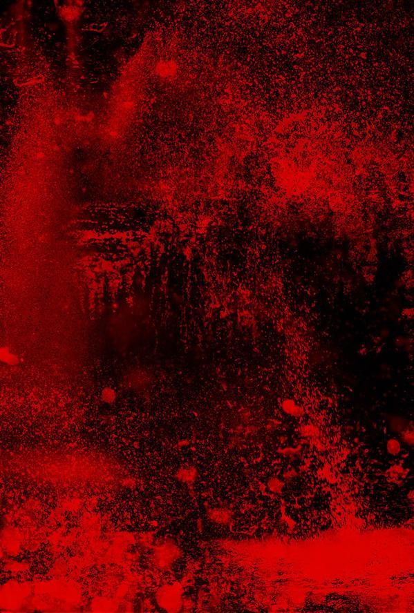 red paint splattered on the wall and floor in front of a black background