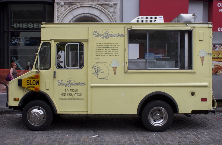 an ice cream truck parked in front of a building