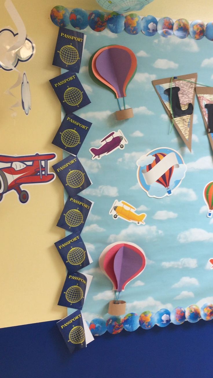 a bulletin board with hot air balloons and kites on it's side in a child's room