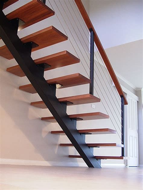 a wooden stair case with metal handrails