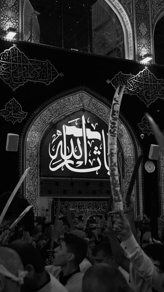 people holding up their hands in front of an ornate building with arabic writing on it